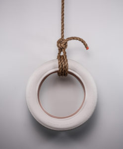 Jocelyn Reid, "Lay your weight on me, I will make you free", 2018, cast porcelain tire, glaze, rope, 20" x 20" x 7"